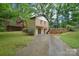 The backyard of this property features a brick house, back deck, and a long cement driveway at 6227 Dogwood Ln, Waxhaw, NC 28173