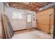 Unfinished basement area with a window and exterior door, perfect for storage or workshop at 6227 Dogwood Ln, Waxhaw, NC 28173