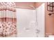 Standard white bath tub with chrome fixtures and a matching shower head offers a relaxing bathing experience at 6227 Dogwood Ln, Waxhaw, NC 28173