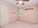 Comfortable bedroom showcasing a ceiling fan, window, and built-in shelf for a functional space at 6227 Dogwood Ln, Waxhaw, NC 28173