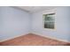 Bedroom space featuring hardwood flooring, ample natural light from a window, and neutral paint at 6227 Dogwood Ln, Waxhaw, NC 28173