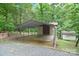 View of a metal carport with a concrete floor and a storage shed nearby at 6227 Dogwood Ln, Waxhaw, NC 28173