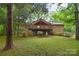 Charming home with a large deck overlooking the landscaped backyard surrounded by lush greenery and mature trees at 6227 Dogwood Ln, Waxhaw, NC 28173