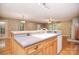 Open-concept kitchen with wood cabinets, laminate counters, a sink, and hardwood floors flowing seamlessly into the living space at 6227 Dogwood Ln, Waxhaw, NC 28173