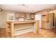 Spacious kitchen with wood cabinets, laminate countertops, white appliances, and hardwood floors, providing a functional space at 6227 Dogwood Ln, Waxhaw, NC 28173