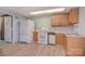 Practical kitchen with essential appliances, wood cabinetry, and durable flooring for easy maintenance at 6227 Dogwood Ln, Waxhaw, NC 28173