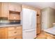 Traditional kitchen showcasing wood cabinets, laminate counters, a modern refrigerator, and hardwood floors for a warm, inviting feel at 6227 Dogwood Ln, Waxhaw, NC 28173