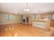Living room featuring wood floors, a fireplace, and a kitchen at 6227 Dogwood Ln, Waxhaw, NC 28173