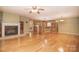 Spacious living room with a fireplace, wood floors, and an open view into the kitchen at 6227 Dogwood Ln, Waxhaw, NC 28173
