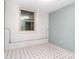 Room with contrasting white walls and blue accent wall complemented by patterned floors and a window at 6227 Dogwood Ln, Waxhaw, NC 28173