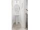 A quaint powder room featuring a pedestal sink, round mirror, and neutral decor at 711 Bellmouth Rd, Clover, SC 29710