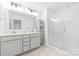 Modern bathroom with double vanities, ample storage, and a glass-enclosed shower at 711 Bellmouth Rd, Clover, SC 29710