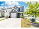 Stylish two-story gray townhome featuring a one-car garage, a well-manicured lawn, and attractive landscaping at 711 Bellmouth Rd, Clover, SC 29710