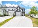Charming townhome featuring a two-car garage, craftsman details, and a well-maintained front yard and driveway at 711 Bellmouth Rd, Clover, SC 29710