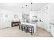 Open kitchen with white cabinets, an island with seating, and seamless flow to adjacent living spaces at 711 Bellmouth Rd, Clover, SC 29710