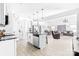 Bright open-concept kitchen features white cabinets, modern lighting, and a large island with seating at 711 Bellmouth Rd, Clover, SC 29710