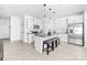 Modern open-concept kitchen with white cabinets, stainless appliances, and an island with bar stool seating at 711 Bellmouth Rd, Clover, SC 29710