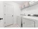 Well-lit laundry room features a washer, dryer, and ample shelving for storage at 711 Bellmouth Rd, Clover, SC 29710
