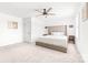 Bright main bedroom featuring a large upholstered bed, neutral tones, and a ceiling fan at 711 Bellmouth Rd, Clover, SC 29710