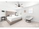 Serene main bedroom with a tufted headboard, ceiling fan, and plush seating area at 711 Bellmouth Rd, Clover, SC 29710