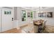 Elegant dining room with a wooden table set for six, complemented by stylish decor and abundant natural light at 7137 Butternut Oak Ter, Huntersville, NC 28078