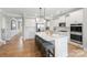 Modern kitchen featuring white cabinetry, a large center island with seating, and stainless steel appliances at 7137 Butternut Oak Ter, Huntersville, NC 28078