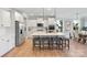 Contemporary kitchen with stainless appliances, central island with bar stool seating and hardwood floors at 7137 Butternut Oak Ter, Huntersville, NC 28078