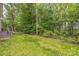 Beautiful backyard with well manicured lawn surrounded by tall shade trees at 8336 Early Bird Way, Mint Hill, NC 28227