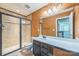 Bathroom featuring walk-in shower, single sink vanity, and warm lighting at 8336 Early Bird Way, Mint Hill, NC 28227