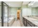 Bright bathroom features a soaking tub, glass-enclosed shower, and granite counters at 8336 Early Bird Way, Mint Hill, NC 28227