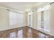 Sunlit bedroom features hardwood floors and three large windows at 8336 Early Bird Way, Mint Hill, NC 28227