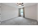 Simple bedroom offers carpet flooring, a ceiling fan and a window at 8336 Early Bird Way, Mint Hill, NC 28227