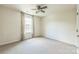 Carpeted bedroom features neutral colors, ceiling fan and window for natural light at 8336 Early Bird Way, Mint Hill, NC 28227