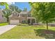Charming two-story brick home featuring a manicured lawn and a two-car garage at 8336 Early Bird Way, Mint Hill, NC 28227