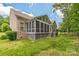 Exterior view featuring brick home with well maintained lawn and screened-in porch at 8336 Early Bird Way, Mint Hill, NC 28227