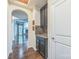Hallway with dark cabinets and granite countertops, with an archway looking into the living room at 8336 Early Bird Way, Mint Hill, NC 28227