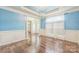 Elegant living room featuring hardwood floors, wainscoting, and tray ceilings with recessed lighting at 8336 Early Bird Way, Mint Hill, NC 28227