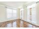 Bright living room featuring hardwood floors, large windows and elegant trim at 8336 Early Bird Way, Mint Hill, NC 28227