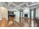 Spacious living room with coffered ceilings, fireplace and view into kitchen at 8336 Early Bird Way, Mint Hill, NC 28227