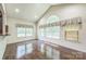 Bright living room with hardwood floors, large windows, and high vaulted ceilings at 8336 Early Bird Way, Mint Hill, NC 28227