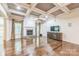 Cozy living room with a stone fireplace, coffered ceiling, and hardwood floors at 8336 Early Bird Way, Mint Hill, NC 28227