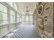 Relaxing sunroom with brick accent wall, wood ceiling, and screened windows at 8336 Early Bird Way, Mint Hill, NC 28227