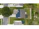 Aerial view of a home with solar panels, a fenced yard, mature trees, and trampoline at 8511 Redding Glen Ave, Charlotte, NC 28216