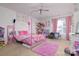 Bright bedroom features a four-poster bed, soft carpet, ceiling fan, and window with pink curtains at 8511 Redding Glen Ave, Charlotte, NC 28216