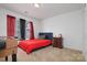 Bedroom with red bedsheets at 8511 Redding Glen Ave, Charlotte, NC 28216