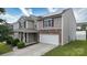 Charming two-story home with a stone-accented garage and manicured lawn at 8511 Redding Glen Ave, Charlotte, NC 28216