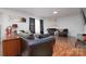 Cozy living room featuring a fireplace, wood floors, and ample natural light at 8511 Redding Glen Ave, Charlotte, NC 28216