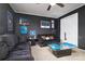 Living room boasts black decor, sports memorabilia, a ceiling fan, and inviting black couches at 8511 Redding Glen Ave, Charlotte, NC 28216