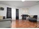 Inviting living room showcasing a fireplace, ample seating, and wood floors at 8511 Redding Glen Ave, Charlotte, NC 28216