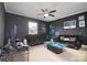 Comfortable living room with dark decor, a ceiling fan, and Carolina Panthers memorabilia at 8511 Redding Glen Ave, Charlotte, NC 28216